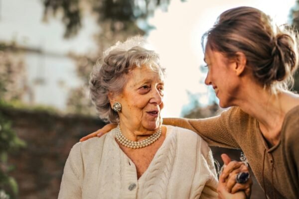 Seniors discussing aged care options with a caregiver.