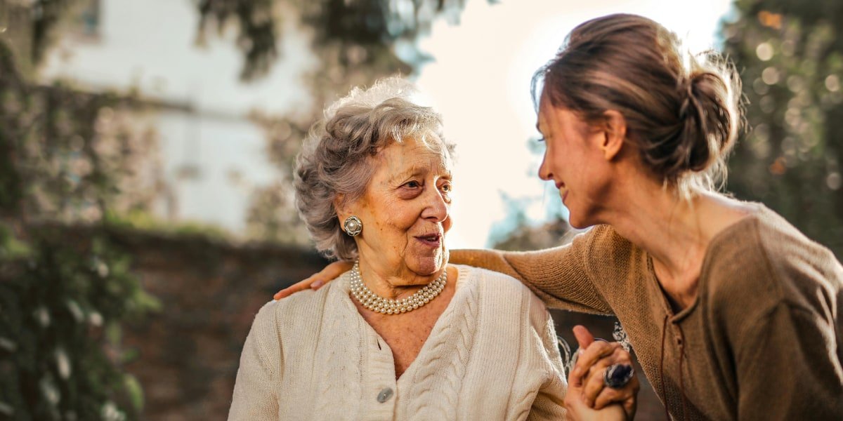 Seniors discussing aged care options with a caregiver.