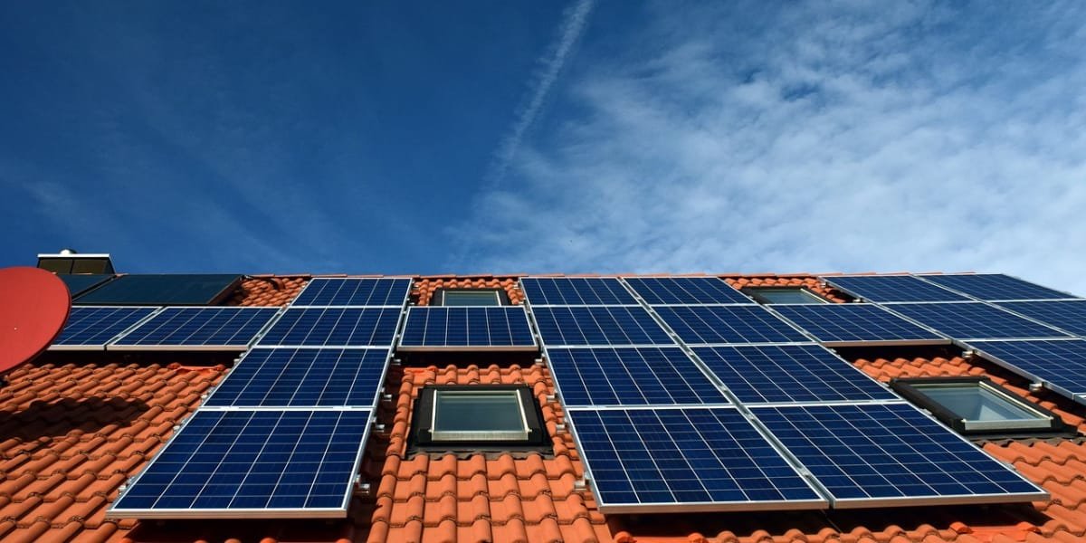 Solar panels on a modern home roof representing property value increase.