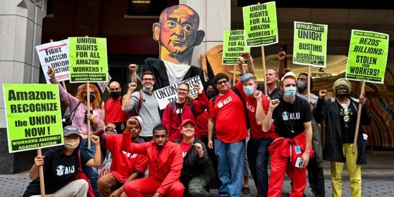 Workers united in a labor union rally holding signs for fair wages and rights.